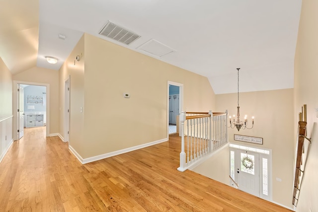 4 Woodmere Dr, Dothan, AL 36305 - hall featuring an upstairs landing, lofted ceiling, light wood finished floors, and a chandelier