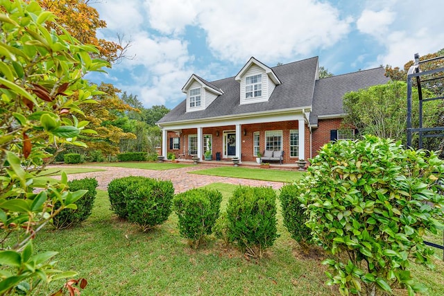 4 Woodmere Dr, Dothan, AL 36305 - cape cod-style house featuring brick siding, a front lawn, a shingled roof, and a porch