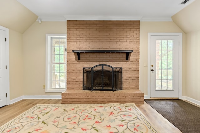 4 Woodmere Dr, Dothan, AL 36305 - living room featuring wood finished floors, vaulted ceiling, a brick fireplace, and crown molding
