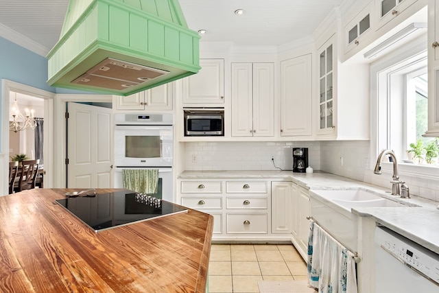 4 Woodmere Dr, Dothan, AL 36305 - kitchen featuring white appliances, a chandelier, light tile patterned flooring, backsplash, and white cabinets