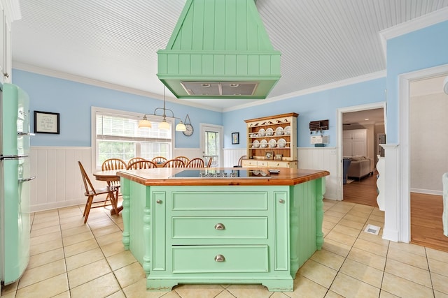 4 Woodmere Dr, Dothan, AL 36305 - kitchen with green cabinets, light tile patterned floors, freestanding refrigerator, wainscoting, and a kitchen island with sink