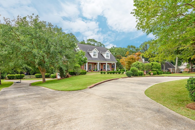 4 Woodmere Dr, Dothan, AL 36305 - cape cod house with a front yard, concrete driveway, and a porch
