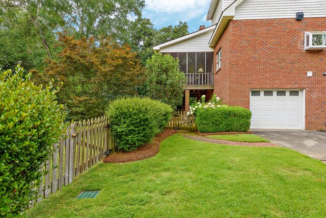 4 Woodmere Dr, Dothan, AL 36305 - view of yard with driveway, a garage, and a sunroom