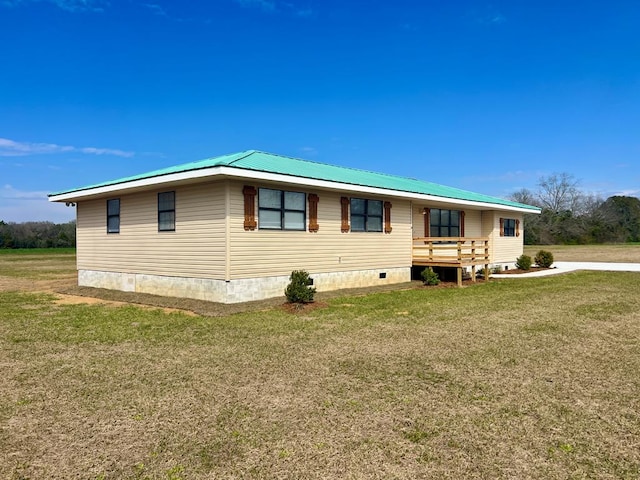 view of front of property with a front yard and metal roof