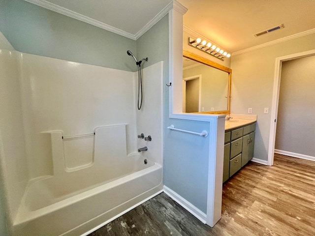 bathroom featuring shower / tub combination, wood finished floors, vanity, visible vents, and ornamental molding