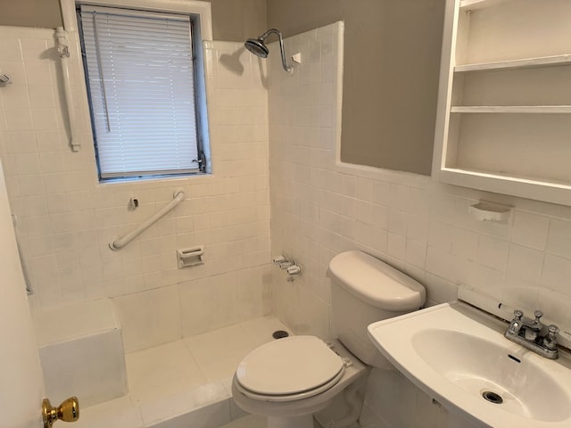 bathroom with a tile shower, toilet, tile walls, and sink