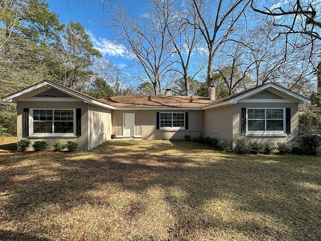 single story home featuring a front lawn