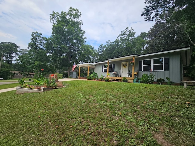 276 Fairview, Ozark, AL 36360 - single story home with a porch, board and batten siding, a carport, a front lawn, and concrete driveway