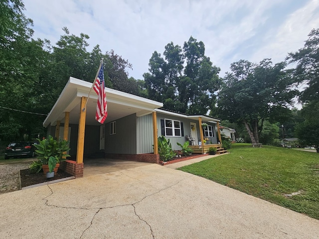276 Fairview, Ozark, AL 36360 - view of front of home with concrete driveway, covered porch, a front lawn, and an attached carport