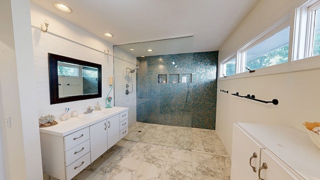 full bathroom featuring marble finish floor, recessed lighting, walk in shower, and vanity