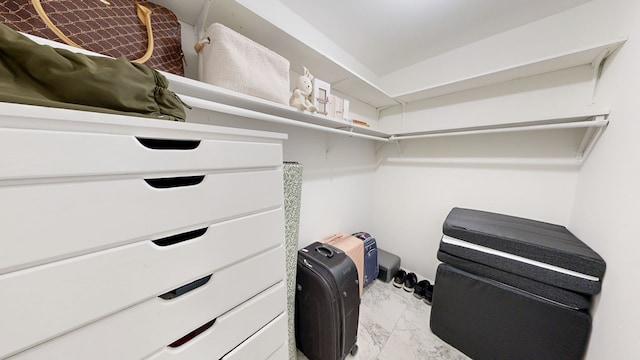 spacious closet featuring marble finish floor