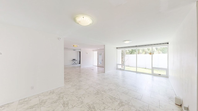empty room featuring light marble finish floors