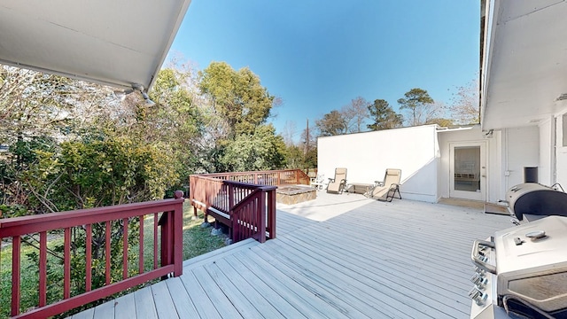 deck featuring an outdoor fire pit