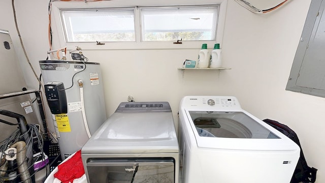 laundry room featuring washer and dryer, laundry area, water heater, and electric panel