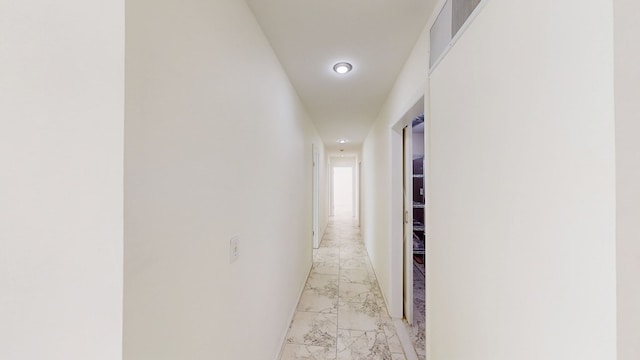 hall featuring marble finish floor and recessed lighting