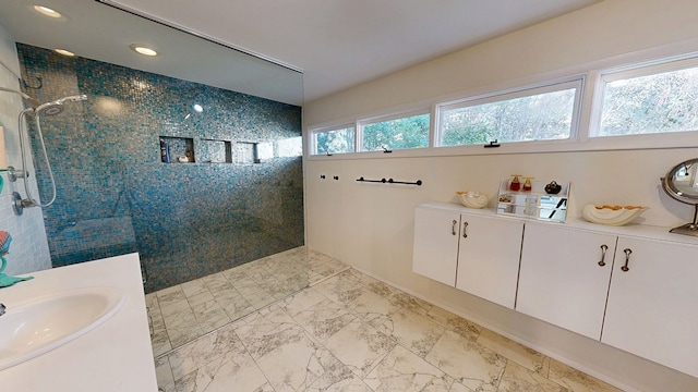 full bathroom featuring marble finish floor, recessed lighting, a walk in shower, and vanity