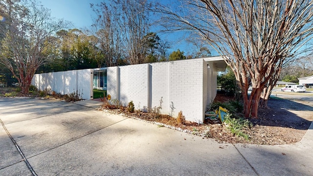 view of side of property with a gate and fence