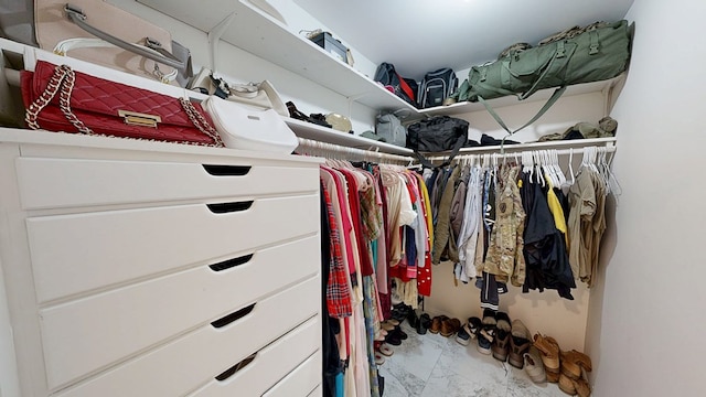 spacious closet featuring marble finish floor