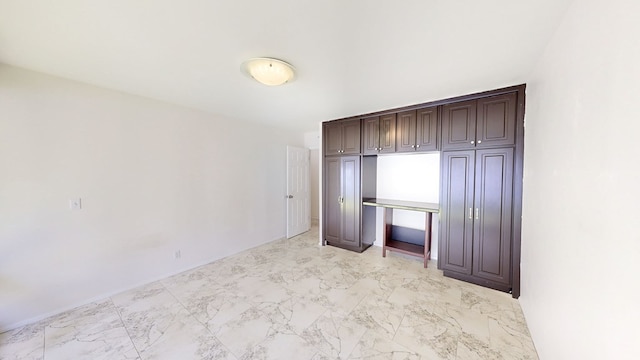 unfurnished bedroom featuring light marble finish floors