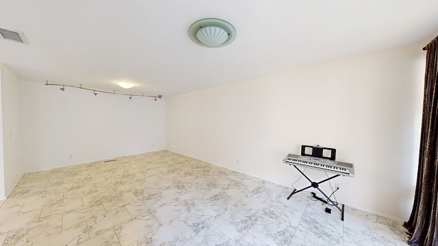 empty room with visible vents and marble finish floor