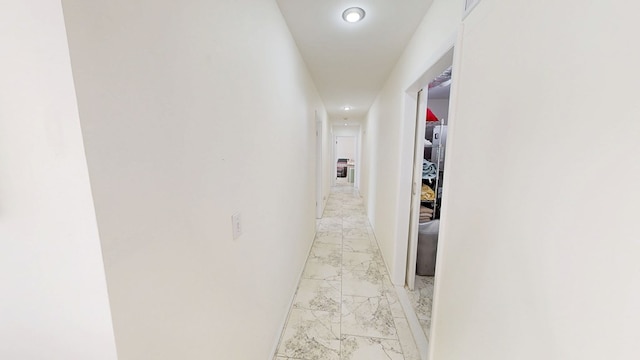 corridor with marble finish floor