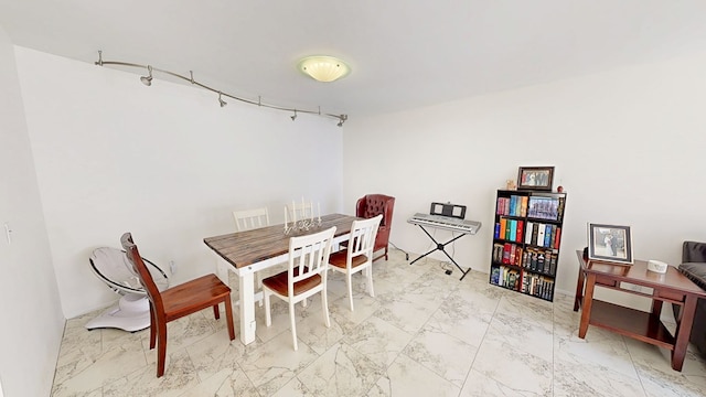 dining area featuring marble finish floor