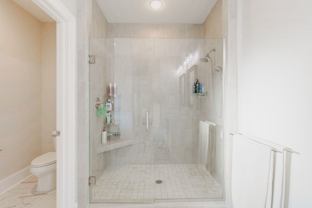 bathroom featuring toilet and an enclosed shower