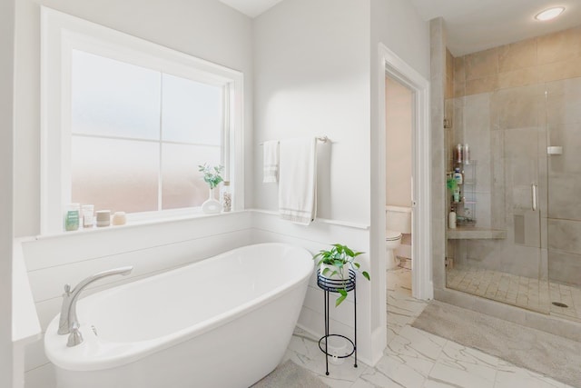 bathroom with separate shower and tub, a healthy amount of sunlight, and toilet