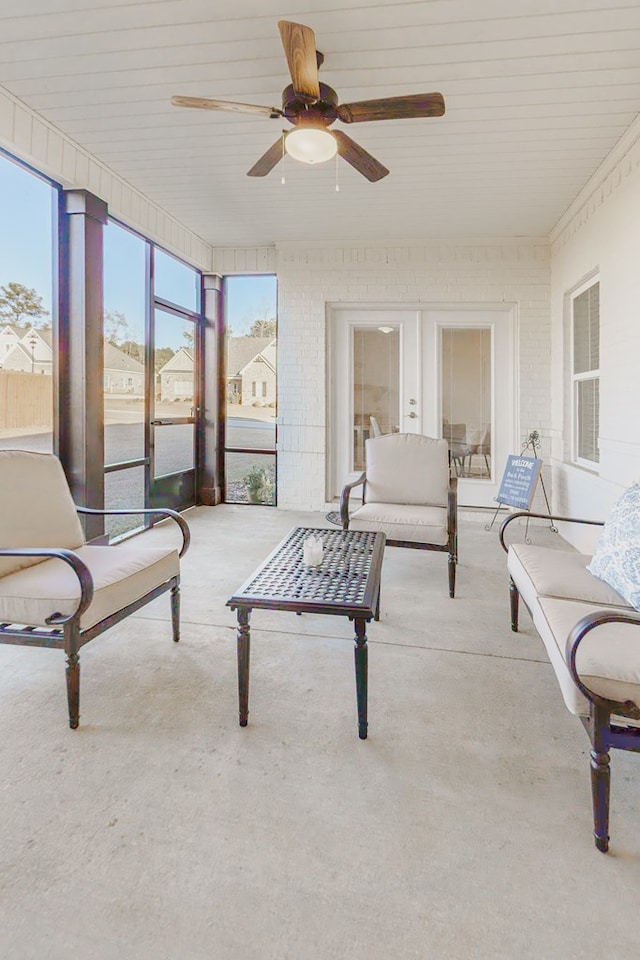 sunroom / solarium featuring ceiling fan