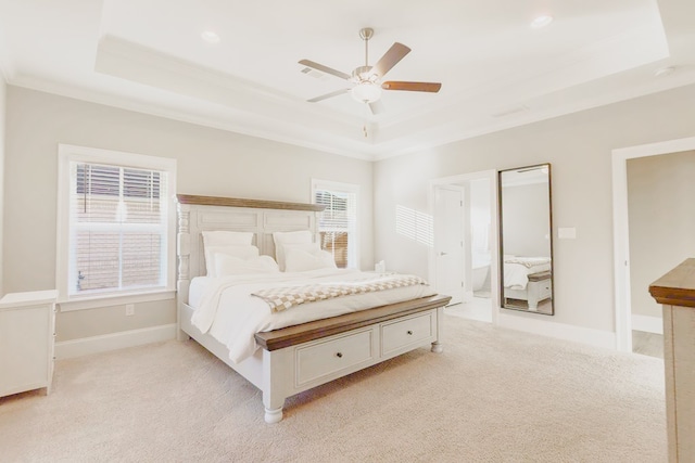 carpeted bedroom with a raised ceiling, ceiling fan, and ornamental molding