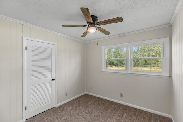 351 Hayborn Rd, Webb, AL 36376 - unfurnished bedroom featuring carpet, ornamental molding, a textured ceiling, ceiling fan, and wooden walls
