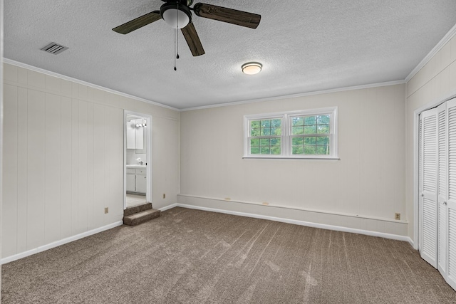 351 Hayborn Rd, Webb, AL 36376 - unfurnished bedroom with carpet, crown molding, a closet, a textured ceiling, and ensuite bathroom