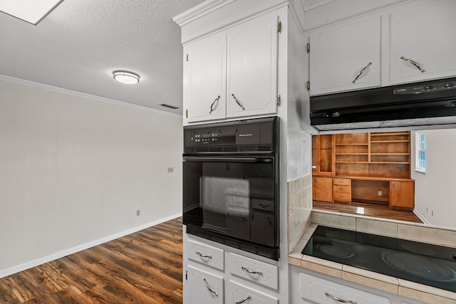 351 Hayborn Rd, Webb, AL 36376 - kitchen with black appliances, dark wood-style floors, white cabinets, exhaust hood, and crown molding