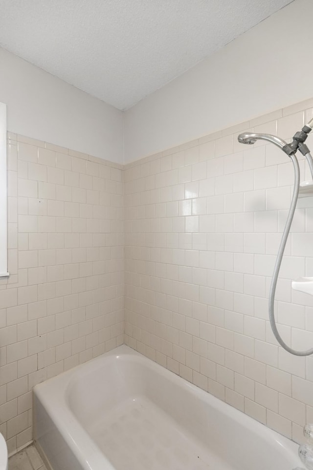 351 Hayborn Rd, Webb, AL 36376 - full bathroom with a tub to relax in, a shower, and a textured ceiling