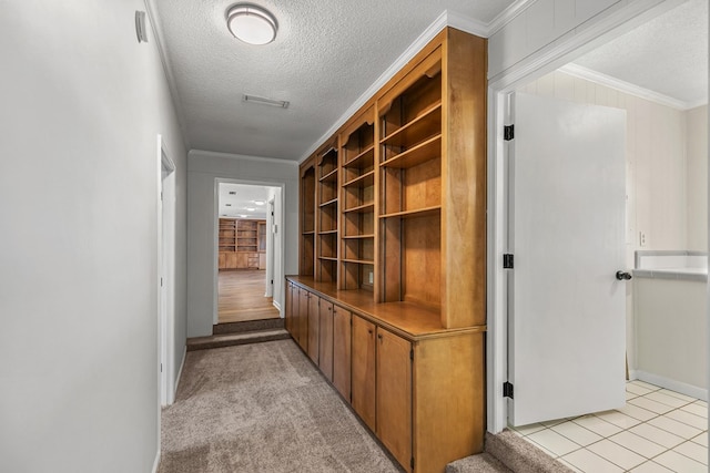 351 Hayborn Rd, Webb, AL 36376 - hallway featuring a textured ceiling, ornamental molding, and light tile patterned floors