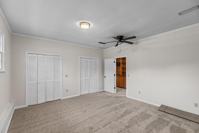 351 Hayborn Rd, Webb, AL 36376 - unfurnished bedroom with ornamental molding, multiple closets, a textured ceiling, and carpet