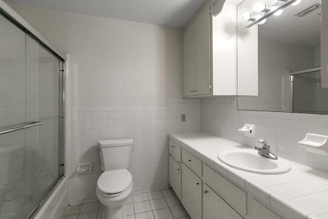 351 Hayborn Rd, Webb, AL 36376 - full bath featuring vanity, tile patterned floors, wainscoting, combined bath / shower with glass door, and tile walls