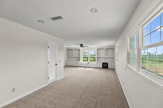 351 Hayborn Rd, Webb, AL 36376 - unfurnished living room with a textured ceiling, carpet flooring, and ceiling fan