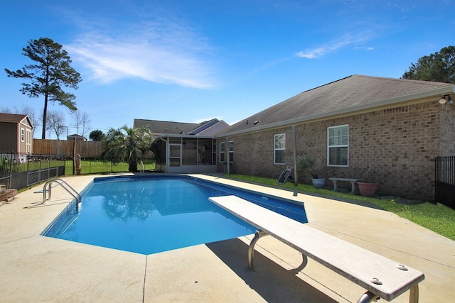 view of pool with a sunroom, a patio area, fence, and a fenced in pool