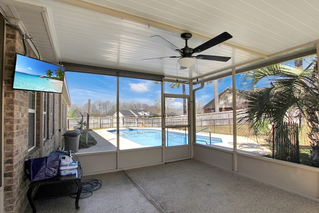 unfurnished sunroom featuring a ceiling fan