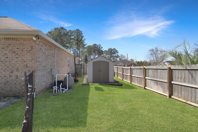 view of yard with a fenced backyard, an outdoor structure, and a shed