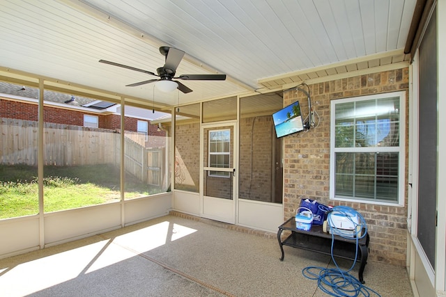 unfurnished sunroom with a ceiling fan