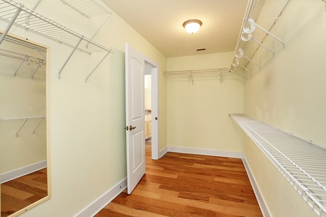 spacious closet with visible vents and wood finished floors