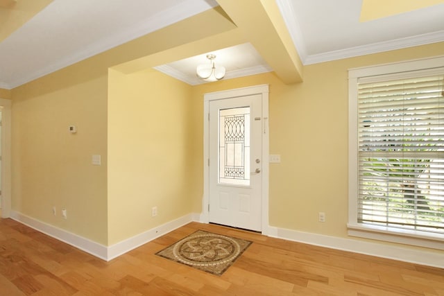 foyer with crown molding, beam ceiling, baseboards, and wood finished floors