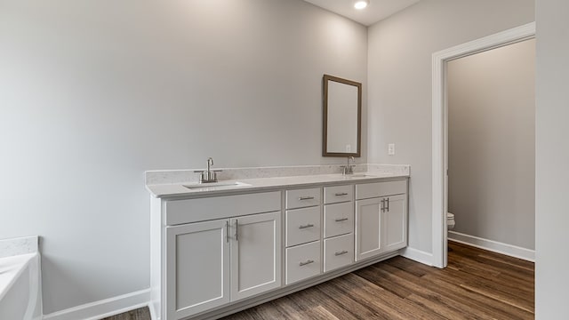 308 Heritage Way, Headland, AL 36345 - full bathroom featuring toilet, baseboards, a sink, and wood finished floors