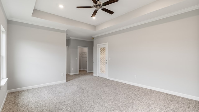 308 Heritage Way, Headland, AL 36345 - empty room featuring ornamental molding, a tray ceiling, light colored carpet, and baseboards