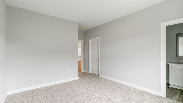 308 Heritage Way, Headland, AL 36345 - unfurnished bedroom featuring ensuite bathroom, carpet floors, and baseboards
