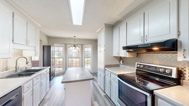 kitchen with under cabinet range hood, a sink, black dishwasher, white cabinetry, and stainless steel range with electric cooktop