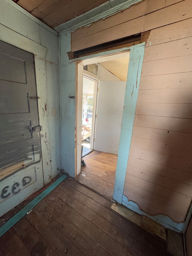 miscellaneous room featuring wood walls and hardwood / wood-style floors