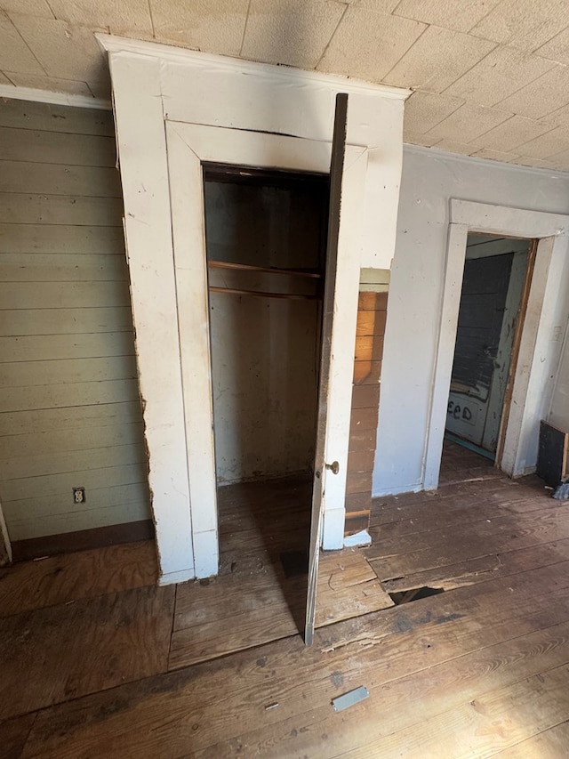 unfurnished bedroom with wood-type flooring and a closet